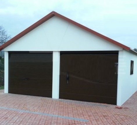 Assembled double garage with plaster and saddle roof